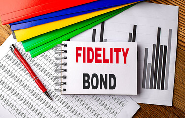 FIDELITY BOND text on notebook with folder on chart