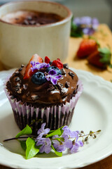 Chocolate muffin cupcakes made from rolled oats, banana, raw cacao powder and topped with chocolate tofu mousse and fresh fruits 