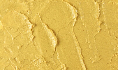 Yellow mustard sauce, spread background and texture, top view