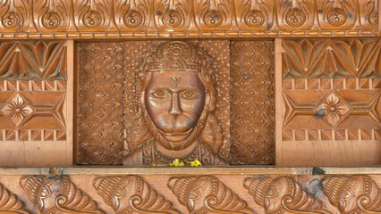 Closeup of The Lord Hanuman ji being engraved on wooden wall at The Hindu temple in Himachal Pradesh.