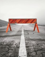 An old, weathered orange barricade blocking a road, indicating construction or a roadblock, set against a grey, foggy background.