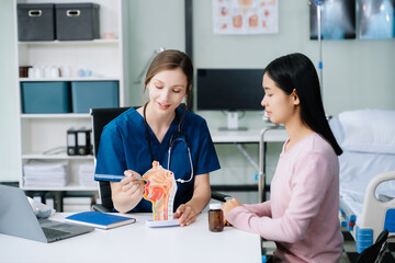 Fototapeta premium Female doctor using clipboard is delivering great news talk discuss results or symptoms with female patient