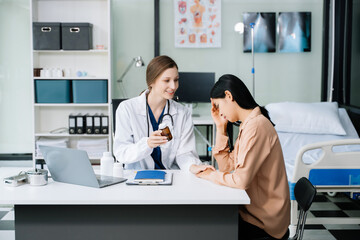 Doctor discussing treatment with Female patient talks to discuss results or symptoms and sitting on examination desk