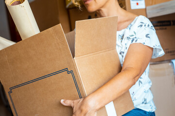 Close up cot out view of adult woman holding carton box for moving mortgage real estate concept....