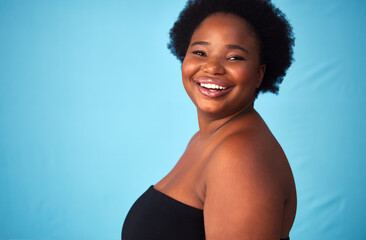 Black woman, smile and plus size for portrait in studio with hair or natural afro, moisture and...