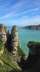 Cliffs, landscape along the Falaise d'Aval, view of the La Manche. Etretat, Normandy, France, English Channel. Natural rocks, coast. Rocks of the village of Etretat in spring in cloudy weather