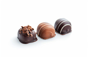 Fototapeta premium three chocolates are lined up on a white surface
