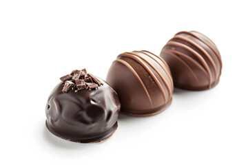 Obraz premium three chocolates are lined up on a white surface