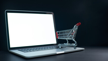 Online shopping concept with laptop and cart