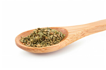 Fototapeta premium a wooden spoon filled with dried herbs on a white surface