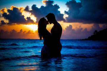 Silhouette of a romantic couple out in the sea kissing as the sun sets over the horizon. Two lovers on a beach sharing an intimate kiss under a beautiful sunset on their honeymoon in the Caribbean.