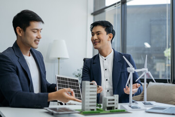 Two colleagues discussing data working and tablet, laptop with on Construction Site project, green energy and solar panel concept.