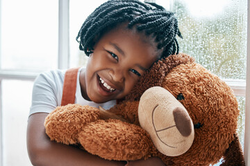 Black girl, portrait and teddy bear in house by window for smile, wellness and playing with toys....