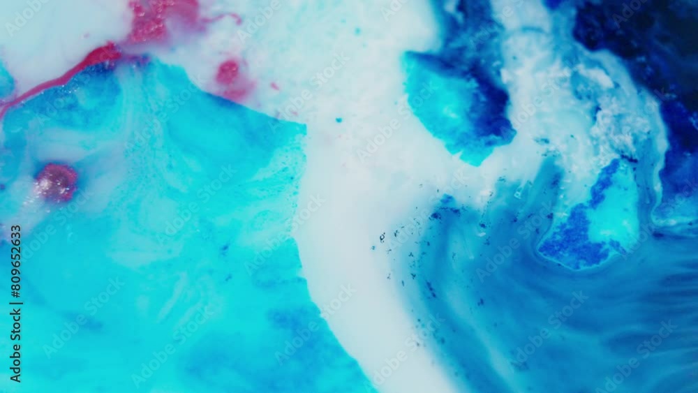 Poster vibrant blue and red ink swirling in water creating a mesmerizing abstract pattern