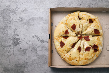 Copy Space Of Pepperoni Pizza With Meat Slices On Cardboard Box Over Grey Background