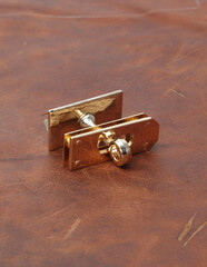 bag and belts metal accessories on leather background