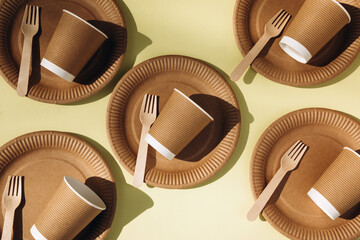 A set of paper utensils and wooden cutlery on a yellow background. Eco friendly, zero waste...
