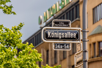 Fototapeta premium street name sign Königsallee, Düsseldorf Germany. Shoppingstreet area