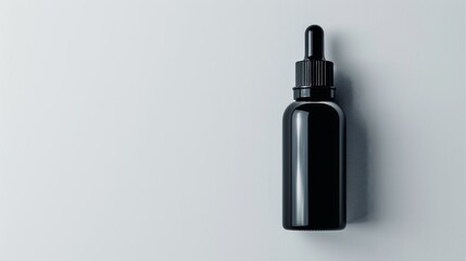 Compact black dropper bottle isolated on white, focusing on portability and ease of use in daily skincare routines
