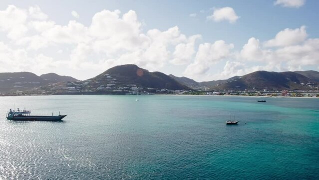 Great Bay near coast of Sint Maarten, view on local fishing sailboats, barge, boats from cruise ship 