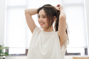 Portrait of beautiful young Asian girl at home