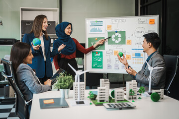 Diverse team, middle-aged Asian businessman, Caucasian young businesswoman, Muslim hijab-wearing...