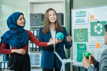 Diverse team, middle-aged Asian businessman, Caucasian young businesswoman, Muslim hijab-wearing...