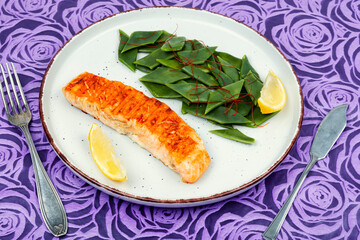 Grilled salmon with vegetable garnish.