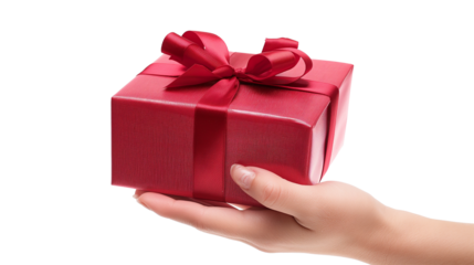 The theme of celebrations and gifts hand holding a gift wrapped in a red box with a red bow isolated on a transparent background