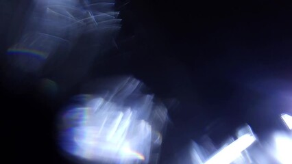 Moving Lens Flare. Defocused Abstract Bokeh Lights on Black Background for Transition Effect. 4K UHD video.