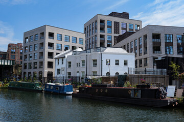 London - 06 04 2022: Residential complex on the Regent's Canal with moored houseboats