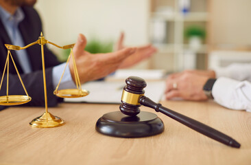 Lawyer professional objects closeup, judge hammer, balance scale justice symbol on table....