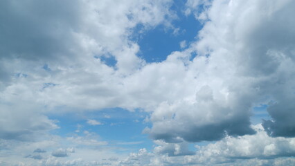 White and gray clouds fly across the sky and change shape. Clearing day and good windy weather....