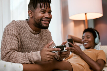 Black couple, sofa and happy with entertainment for bonding, playing and streaming at home. Man,...