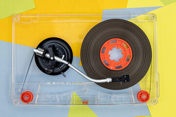 Top view of Turntable arm on old vintage retro audio tape cassettes with a background of...