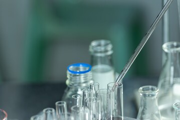 Close-up of a chemistry lab experiment with a pipette and test tubes