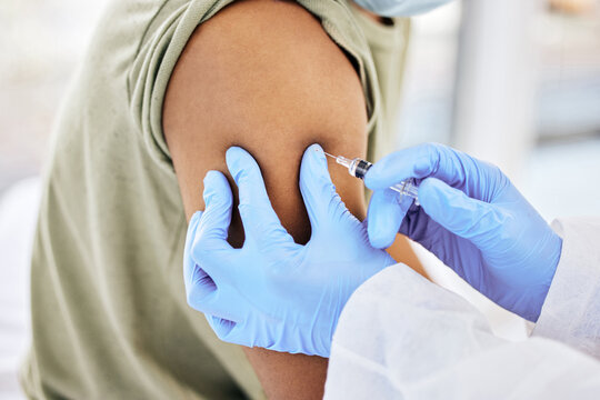 Hands, doctor and patient in clinic with injection for vaccines, cure and prevention for illness. People, arm and needle syringe for medical care or treatment to support, help and trust in hospital