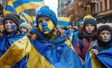 hildren with face painted in the colors of the Ukrainian flag, wrapped up and holding hands wearing a blue coat standing on a street lined with people cheering them - Powered by Adobe