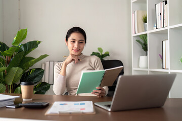 Beautiful asian young woman sit using computer laptop with relax smile. Freelance woman working online sale marketing. Shopping online at home