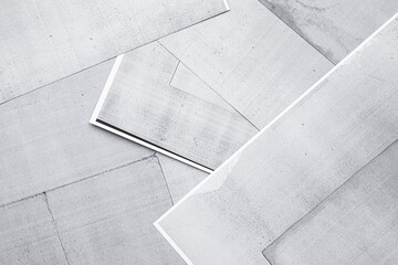 Gray sheets of copier paper lie unevenly on desk