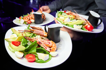 Salad with avocado, tiger prawns, tomatoes and quail eggs