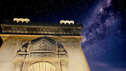 The iconic Patuxay Victory Monument in Vientiane, Laos, dramatically lit against a vivid starry...