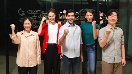 Group of businesspeople applause to celebrate successful project while looking at camera....