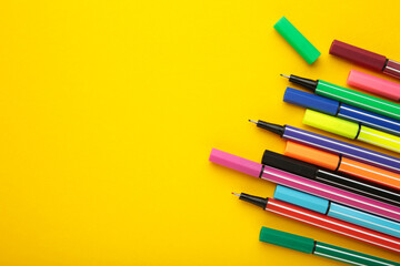 Colorful pen on yellow background. Space for text