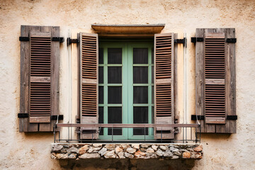 Fototapeta na wymiar An old wooden window with shutters. Traditional European architecture. Vacation travel