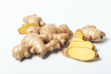 Fresh ginger root with slices on white background