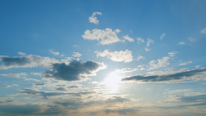 Beautiful blue sky with sunbeams and clouds. Clouds at blue sky background. Sunny cloudscape....