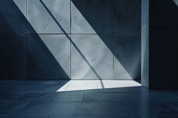 A large room with a wall of grey stone and a window that lets in sunlight
