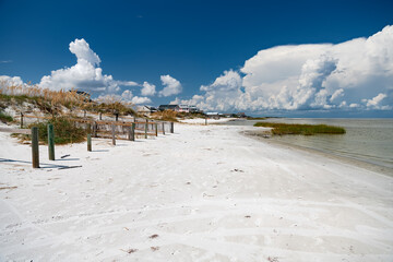 White sand and houses under the clouds on the shores of the Atlantic Ocean.