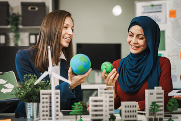 Diverse team, middle-aged Asian businessman, Caucasian young businesswoman, Muslim hijab-wearing...